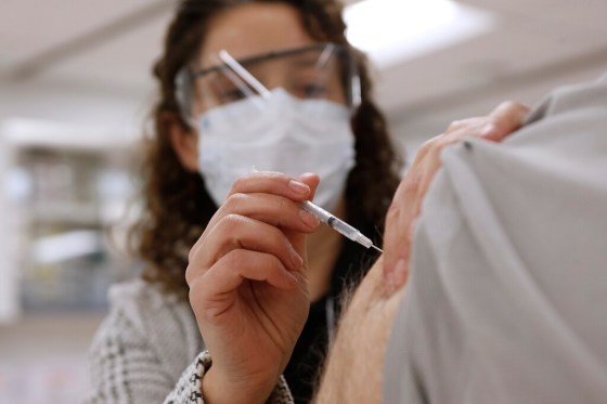 Public health nurse LoriAnn Laramee administers a vaccine shot at Health Sciences Centre in Winnipeg in December. (John Woods / The Canadian Press files)