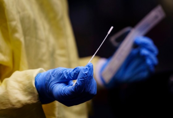 CPA nurse gets a swab ready to perform a COVID-19 test. (Paul Chiasson / The Canadian Press files)