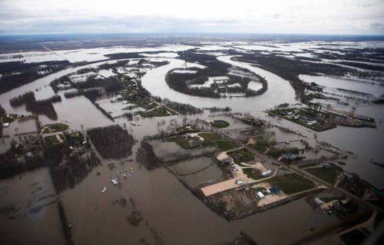 The Red River stretches far beyond its banks south of Winnipeg on Sunday. (John Woods / The Canadian Press files)