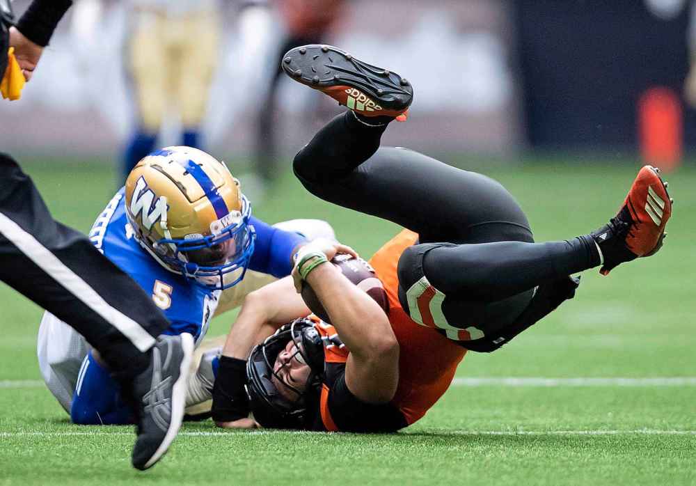 THE CANADIAN PRESS
DARRYL DYCK / THE CANADIAN PRESS
B.C. Lions quarterback Nathan Rourke, right, is sacked by Winnipeg Blue Bombers' Willie Jefferson during the first half.