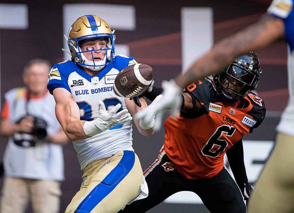 THE CANADIAN PRESS
DARRYL DYCK / THE CANADIAN PRESS
Winnipeg Blue Bombers' Dalton Schoen makes a reception in the end zone to score a touchdown as B.C. Lions' T.J. Lee defends during the first half.