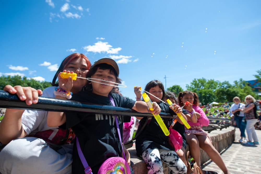 ETHAN CAIRNS / WINNIPEG FREE PRESS
A child blows bubbles at the A New Day Ceremony at The Forks Plaza in Winnipeg, Manitoba on Friday, July 1, 2022