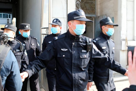 CPSecurity officers stand guard outside a court building in Dandong, China before a trial for Michael Spavor. (Ken Moritsugu / The Associated Press)
