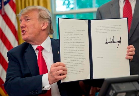 Pablo Martinez Monsivais / The Associated PressPresident Donald Trump holds up the executive order he signed to end family separations at the border on Wednesday.