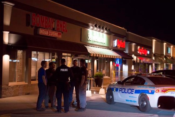 Doug Ives / THE CANADIAN PRESSPolice stand outside the Bombay Bhel restaurant in Mississauga, Ont. on Friday.