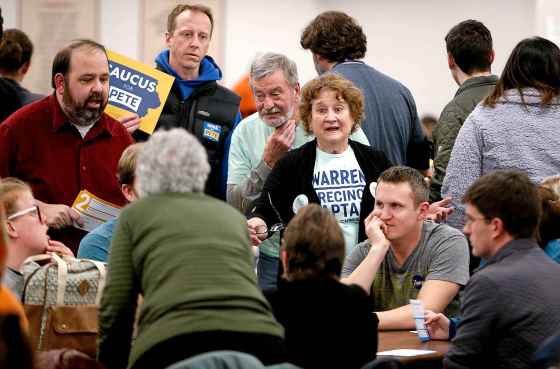 Dave Kettering / Telegraph HeraldElizabeth Warren supporters try to convince others to join their efforts during the Democratic caucus at the Tri-State Independent Blind Society in Dubuque, Iowa, on Monday.