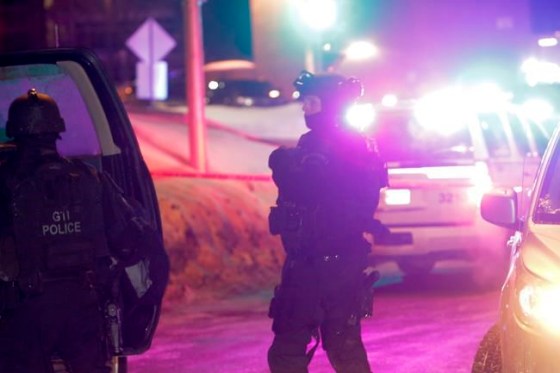 Francis Vachon / THE CANADIAN PRESSPolice survey the scene of a shooting at a Quebec City mosque on Sunday.