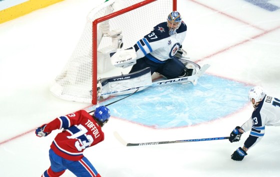 CPTyler Toffoli scores on Jets goalie Connor Hellebuyck in overtime. (Paul Chiasson / The Canadian Press)