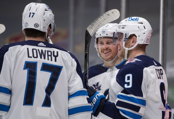 CPWinnipeg Jets forwards Adam Lowry, Nikolaj Ehlers and Andrew Copp celebrate Copp's fourth goal against the Vancouver Canucks Wednesday night. (Darryl Dyck / The Canadian Press)
