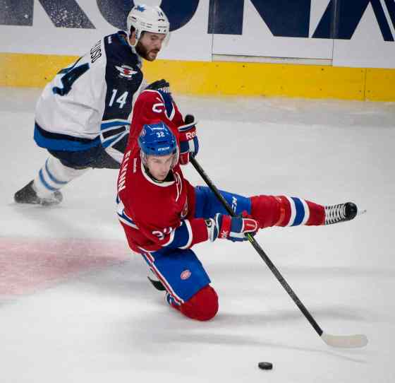 Peter Mccabe / THE CANADIAN PRESSMontreal Canadiens' Brian Flynn, right, goes down as he tries to skate away from Winnipeg Jets' Anthony Peluso during third period NHL action Sunday.