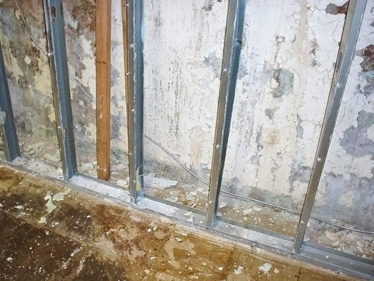 Flaking basement concrete walls.