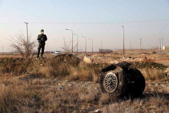 THE ASSOCIATED PRESSA police officer stands guard near debris from the January 2020 crash. (Ebrahim Noroozi / The Associated Press files)