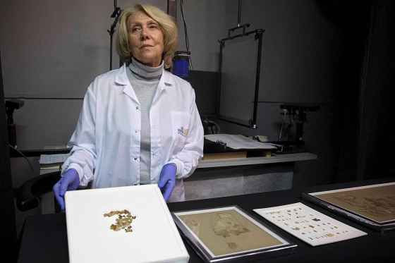 APIsrael Antiquities Authority conservator Tanya Bitler shows newly discovered Dead Sea Scroll fragments at a lab in Jerusalem. (Sebastian Scheiner / The Associated Press)