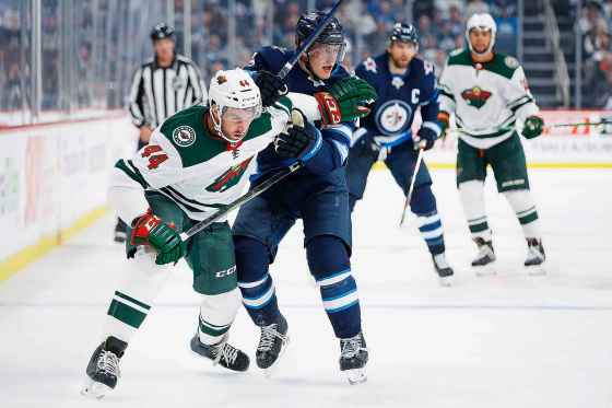 JOHN WOODS / THE CANADIAN PRESSMinnesota Wild's Matt Bartkowski (44) and Winnipeg Jets' Andrew Copp (9) fight for position in Winnipeg.