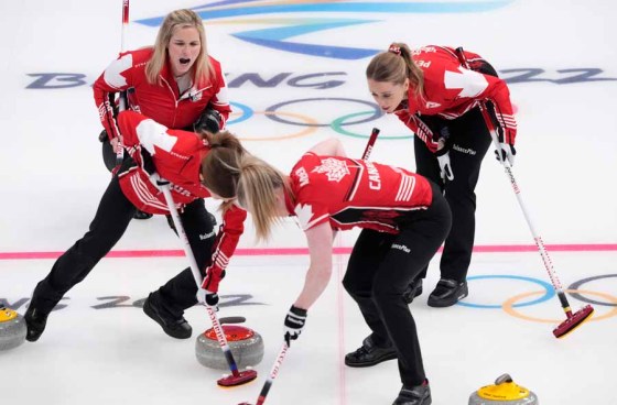 Paul Chiasson / The Canadian PressSkip Jennifer Jones (left) and second Jocelyn Peterman call on third Kaitlyn Lawes (bottom left) and lead Dawn McEwen to sweep at the 2022 Winter Olympics in Beijing. (Paul Chiasson / The Canadian Press files)