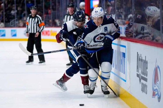 Jets centre Mark Scheifele is pressured by Avalanche winger Andre Burakovsky during a game in Denver on Jan. 6. (Jack Dempsey / The Associated Press files)