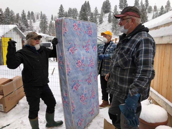 Joy Dougans (from left), Keith Rudance and Alvin Klassen discuss their next move during clean-up work. (John Longhurst / Winnipeg Free Press)