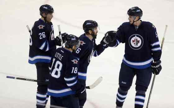 Trevor Hagan / The Canadian PressWinnipeg Jets' Blake Wheeler (26), Bryan Little (18), Andrew Ladd (16)  and Tyler Myers (57) celebrate after Ladd scored an empty net goal against the New York Rangers during third period NHL hockey action in Winnipeg.