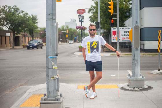 Tyler Sneesby at the intersection of Broadway and Maryland Street. (Mikaela MacKenzie / Winnipeg Free Press)