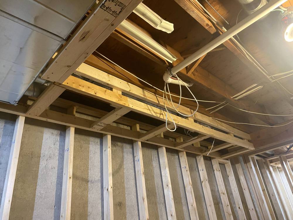 The bulkhead is continued at same elevation and depth, to provide a lineal surface the suspended ceiling grid can be fastened to.