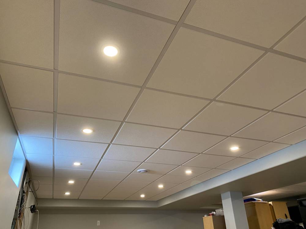 The grid layout for a suspended ceiling in a rectangular area is usually centred within the perimeter mounting surfaces.