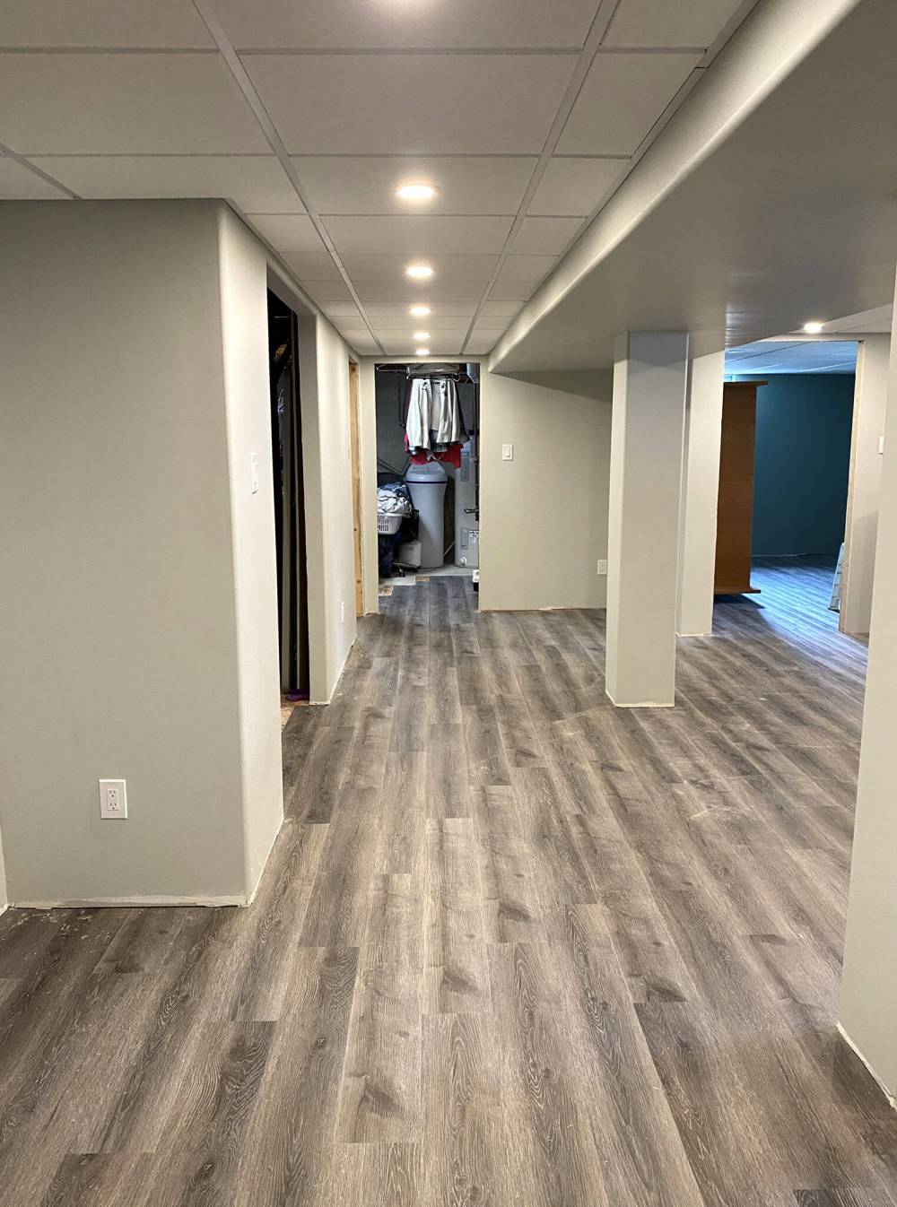 The orientation of the flooring was established by setting the vinyl plank parallel to the long of the main rec-room and hallway.
