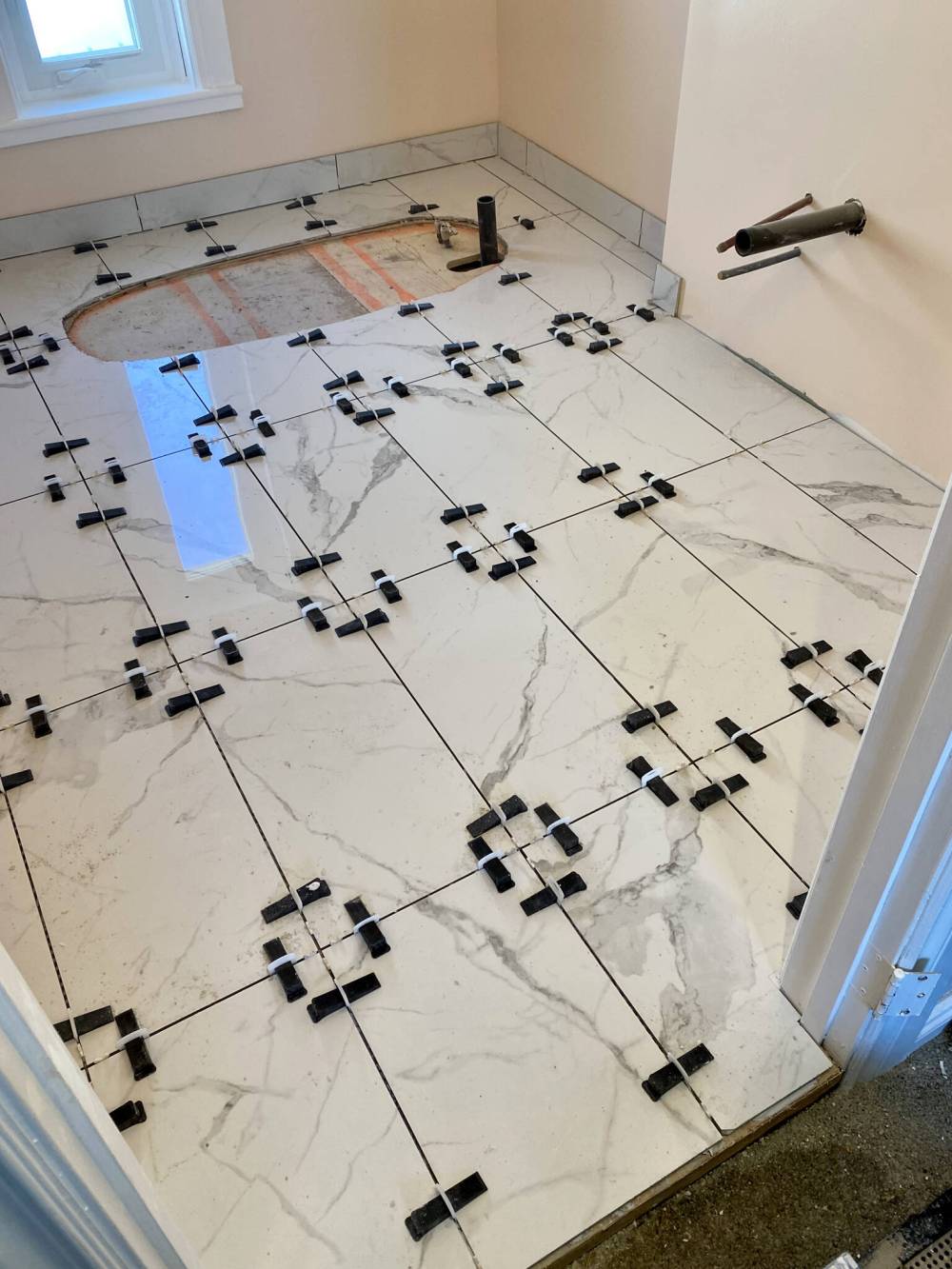 Photos by Marc LaBossiere / Winnipeg Free Press
Once tile layout has been established, the tile are set and levelled using the RUBI Delta Tile Leveling System.