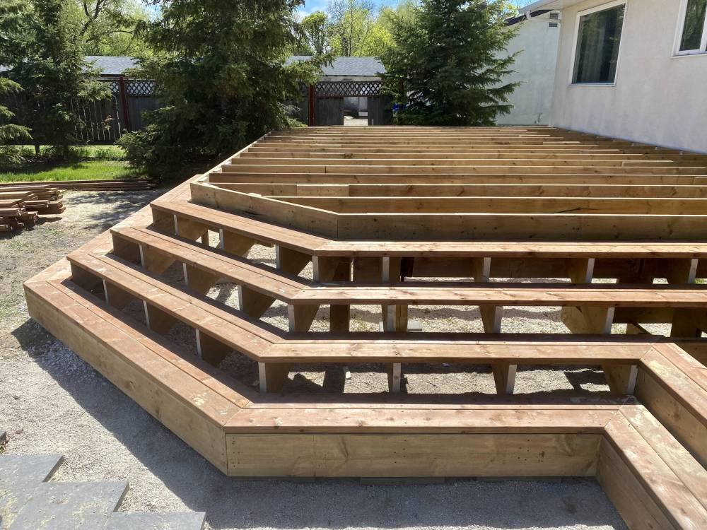 Tandem 2x6 boards are mounted along the stringer tops allowing access to the upper deck for main top-decking installation.