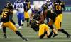 THE CANADIAN PRESS/John Woods
Winnipeg Blue Bombers’ Nic Demski (10) gets tackled by Hamilton Tiger-Cats’ Kameron Kelly (11) and Simoni Lawrence (21) during the first half in Winnipeg, Friday.