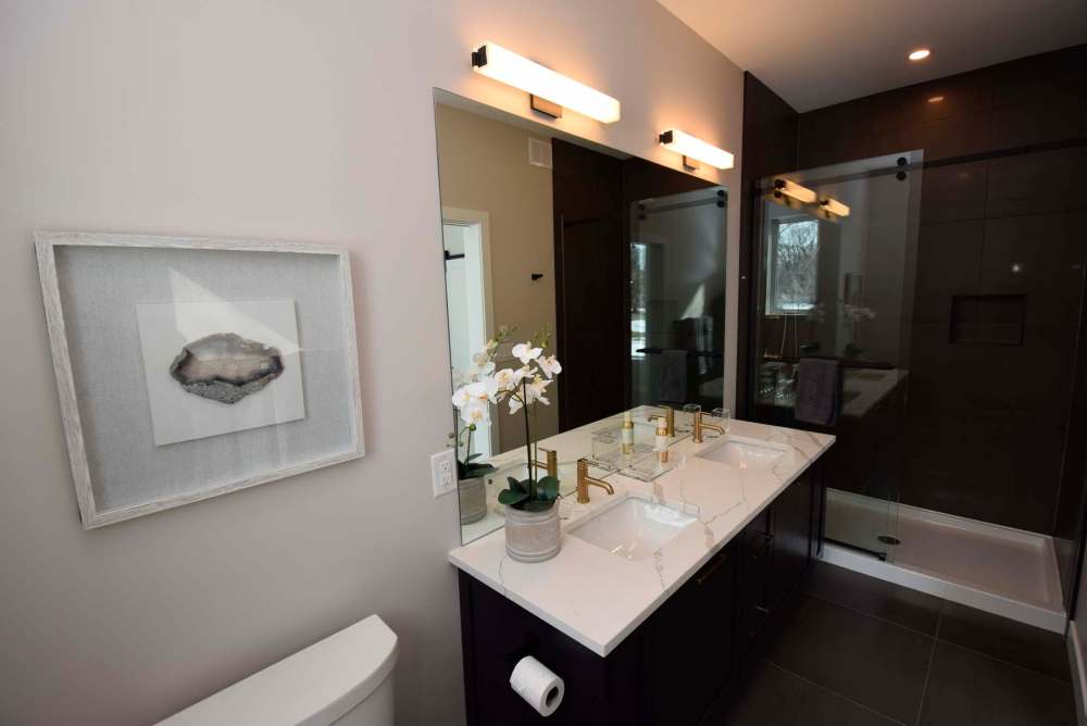 The home’s bathrooms make use of gorgeous quartz countertops.