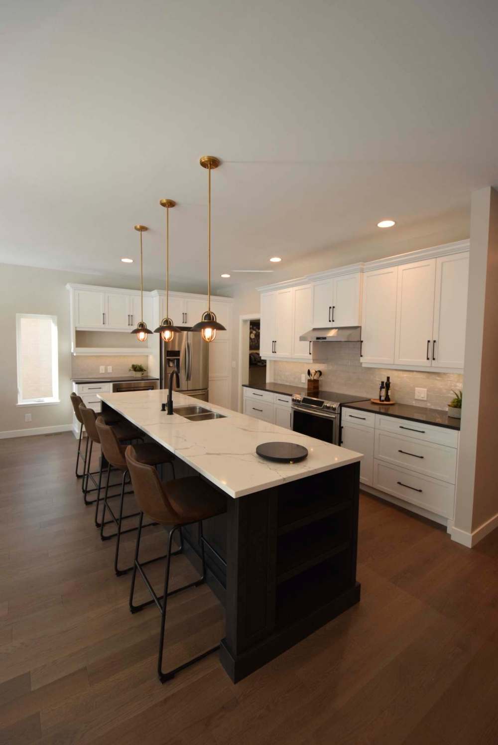 The island in the home’s open, well-lit kitchen seats four. There’s also a dining-room space.