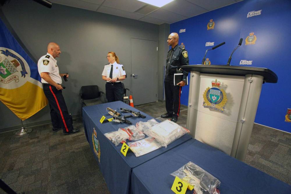 ERIK PINDERA / WINNIPEG FREE PRESS
Winnipeg Police Service Insp. Elton Hall, Canadian Border Services Agency intelligence and enforcement division prairie region director Jeryn Peters, and WPS spokesman Const. Claude Chancy following a press conference Thursday about 3D-printed guns.
