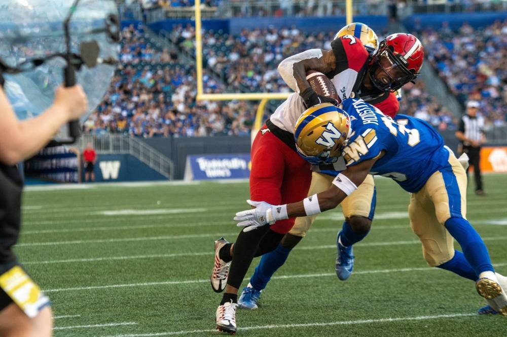 ETHAN CAIRNS / WINNIPEG FREE PRESS
Demerio Houston of the Winnipeg Blue Bombers tackles Malik Henry of the Calgary Stampeders IG field in Winnipeg on Friday.