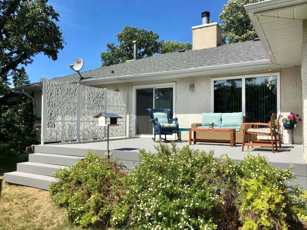 Photos by Marc LaBossiere / Winnipeg Free Press
Light grey Trex composite was used as top-decking and fascia for this deck build (above) and white powder-coated posts with decorative plastic privacy panels created a custom privacy wall (below).
