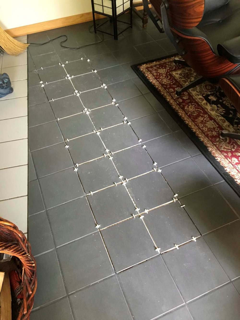 Two rows of tiles are installed using rubber spacers to eliminate any shifting while the tile adhesive sets.