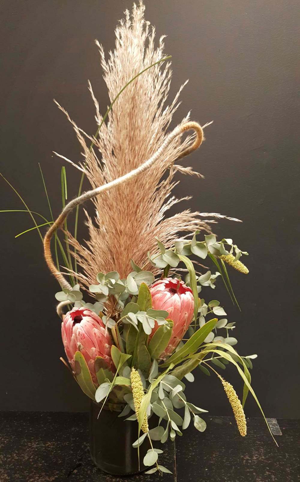 Poppy Parsons
Floral designer Poppy Parsons combines a pampas plume with exotic protea blooms for a wild prairie look. Below: