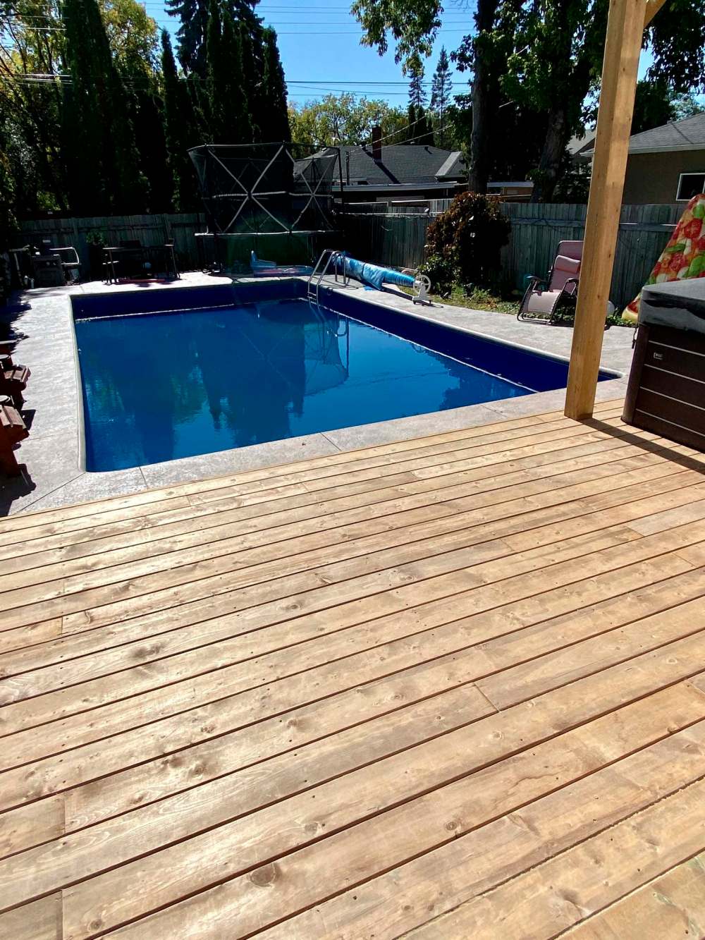The near ground-level deck offers the perfect access from decking to concrete pool perimeter.