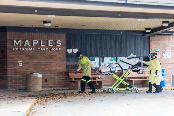 The Stretcher Service of Manitoba wheels a gurney into the building at the Maples long term care home in Winnipeg on Nov. 9. (WINNIPEG FREE PRESS FILES)