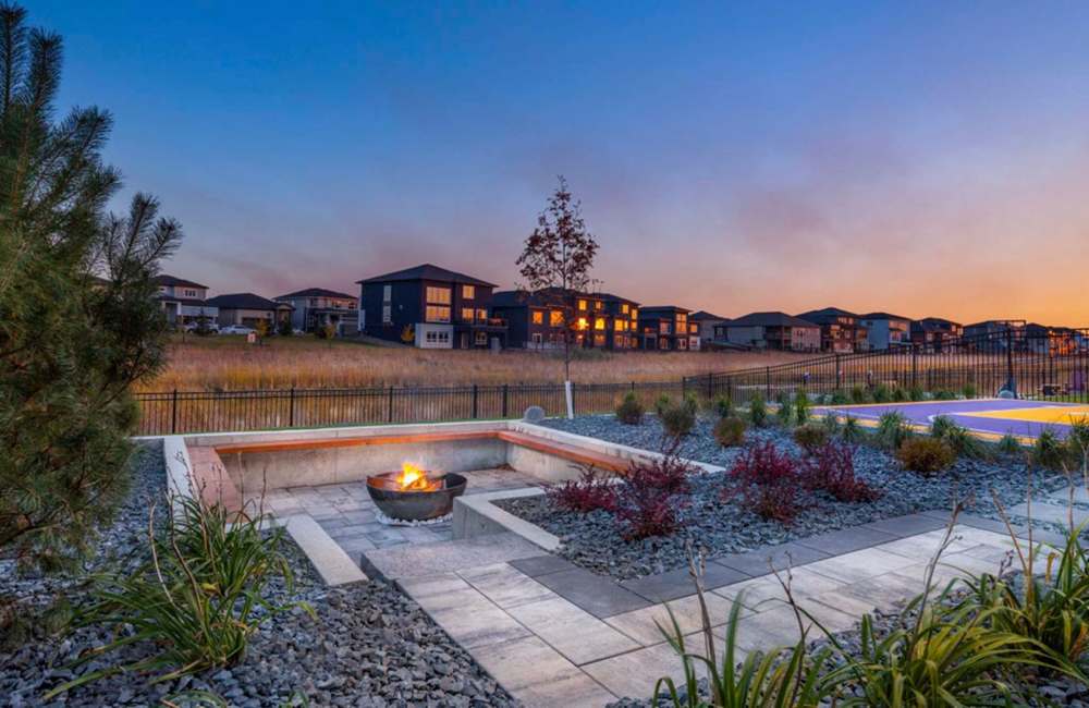 Cosy up in a sunken fire pit with wooden benches and a steel fire bowl.