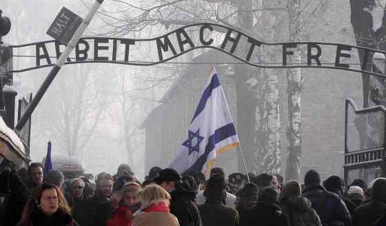 Czarek Sokolowski / The Associated Press FilesVisitors from around the world passing under the infamous Arbeit Macht Frei 'Work Sets You Free' sign over the main gate at the former Nazi death camp of Auschwitz.