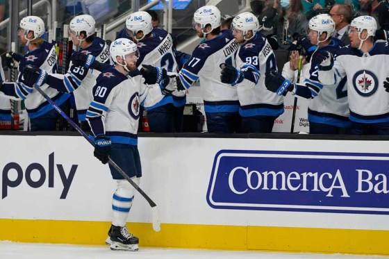 Winnipeg Jets centre Pierre-Luc Dubois is congratulated by teammates, including Blake Wheeler, after scoring against the San Jose Sharks on Saturday. (Jeff Chiu / The Associated Press files)