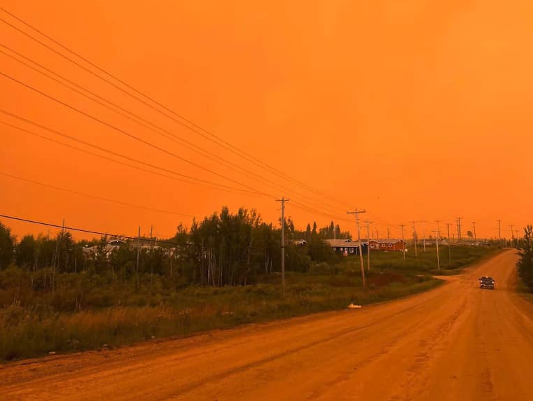 The sky over Pukatawagan is orange on Thursday. (Thompson Firefighters Professional Association photo)