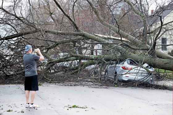 Mark Humphrey / The Associated PressA resident photographs damage after a tornado touched down Tuesday in Nashville, Tenn.