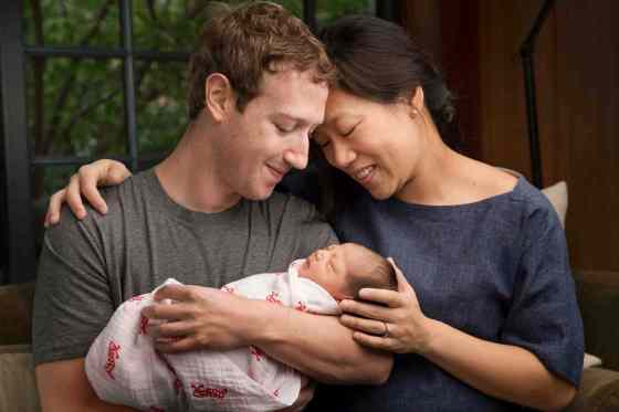 Mark Zuckerberg via The Associated PressMax Chan Zuckerberg is held by her parents, Mark Zuckerberg and Priscilla Chan Zuckerberg.