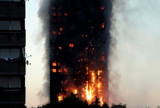 Matt Dunham / The Associated PressSmoke and flames rise from building on fire in London, Wednesday.