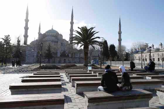 Emrah Gurel / The Associated PressVisitors sit in front of Blue Mosque at the historic Sultanahmet district after an explosion in Istanbul, Tuesday.