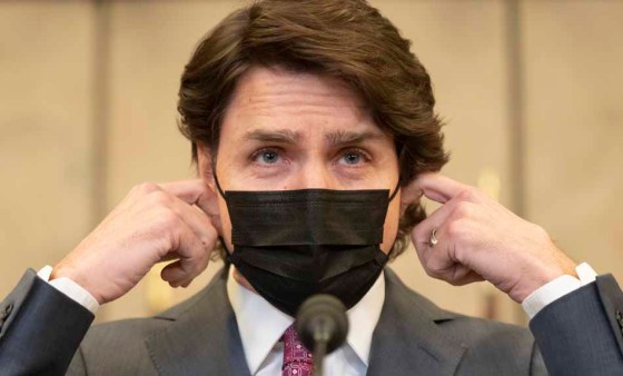 CPJustin Trudeau removes his mask before announcing the Emergencies Act will be invoked. (Adrian Wyld / The Canadian Press)