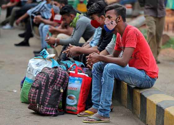 CPTravellers wait for trains in Bengaluru, India, today. (Aijaz Rahi / The Associated Press)