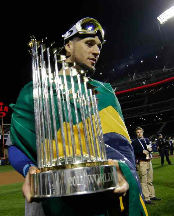 Matt Slocum / The Associated PressKansas City Royals' Paulo Orlando holds the World Series after Game 5 of the Major League Baseball World Series against the New York Mets Monday, in New York. The Royals won 7-2 to win the series.
