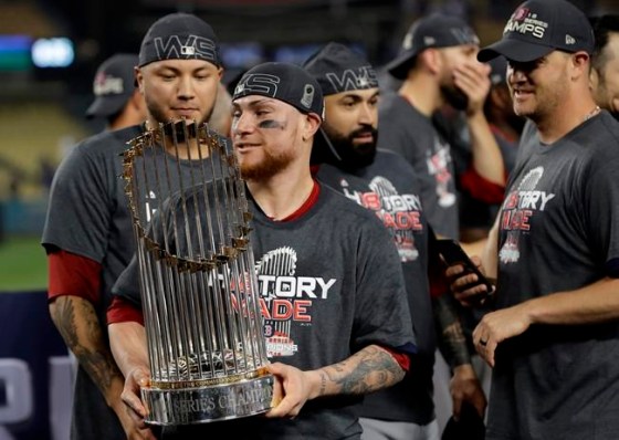David J. Phillip / The Associated PressBoston Red Sox catcher Christian Vazquez holds the championship trophy after Game 5 of baseball's World Series against the Los Angeles Dodgers on Sunday.